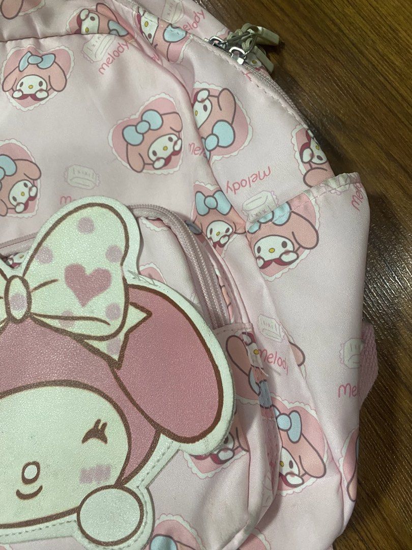 My Melody Kid’s Backpack (Category: Babies & Kids Fashion) located in Makati City. Submitted by ann.declutter (Listing ID 1440653789, Image 3). Description: - Adorable pink backpack featuring a repeating My Melody pattern. - Large My Melody applique on the front pocket. - Stylish silver-toned zippers. - Adjustable straps for a comfortable fit. - Ideal for school, travel, or everyday adventures..