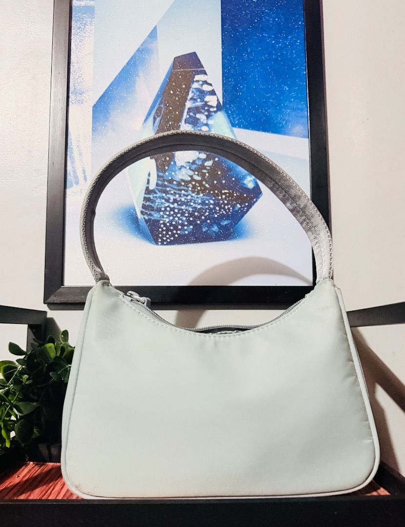 PRADA RE-EDITION NYLON BAG (Category: Luxury Bags & Wallets) located in Infanta. Submitted by christianodelrosario0700 (Listing ID 1440676571, Image 2). Description: Prada Re-Edition Nylon Bag Guaranteed authentic Personal preloved Sky Blue Color Minimal signs of usage, barely used 10/10 excellent condition Bought from Japan 🇯🇵 💫If you know Amore Vintage Shop no inclusion but have different Dust bag From other brand note: color may vary due to