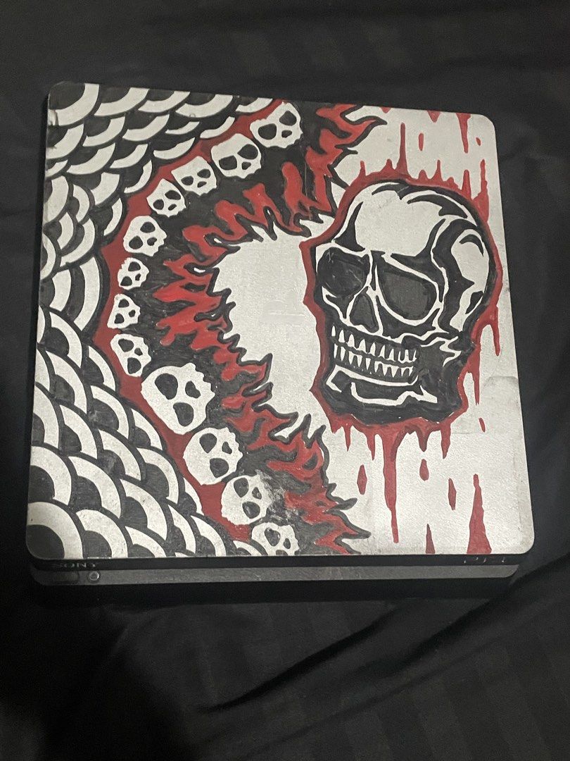 PS4 Slim Console with 2 Controllers (Category: PlayStation) located in Iloilo. Submitted by wiredknives (Listing ID 1440686634, Image 3). Description: *NEGOTIABLE* Clean and well-maintained PS4 Slim with custom hand-painted/customized design 🎨💀 US-bought unit and runs smoothly with no overheating or performance issues. 🎮 Includes: * PS4 Slim 1TB * 2 Controllers * HDMI + Power Cable 📌 Notes: * Black controller works perfectly * Camo controller