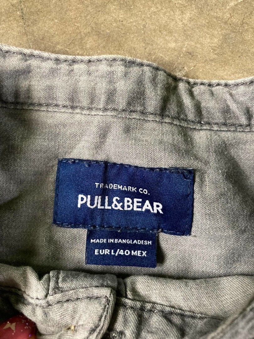 Pull & Bear Grey Striped Band Collar Long Sleeve Shirt (Category: Tshirts & Polo Shirts ) located in Cavite. Submitted by eures_corner (Listing ID 1440600834, Image 2). Description: - Brand: Pull & Bear - Color: Grey - Style: Long sleeve shirt - Collar: Band collar - Closure: Button-up front - Pattern: Subtle stripe - Estimated Size: L - Occasion: Casual wear.