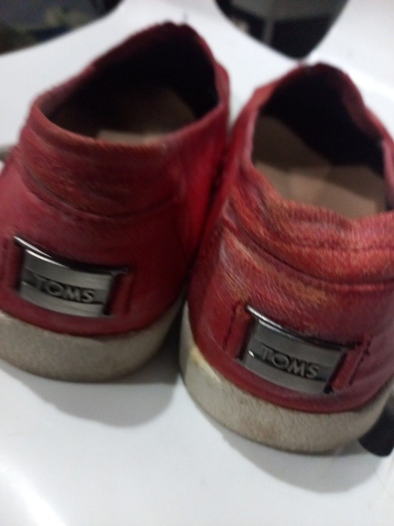 Red TOMS Slip-On Shoes (Category: Flats & Sandals) located in Marikina City. Submitted by soooorome (Listing ID 1440716433, Image 3). Description: - Red TOMS slip-on shoes - Classic canvas style - Soles show some wear - Features TOMS 'One for One' message on insoles - Ideal for casual wear.