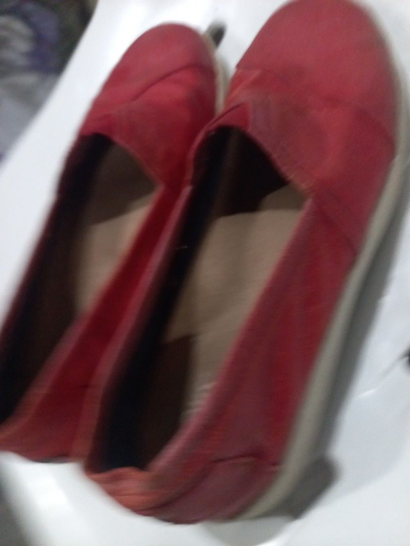 Red TOMS Slip-On Shoes (Category: Flats & Sandals) located in Marikina City. Submitted by soooorome (Listing ID 1440716433, Image 2). Description: - Red TOMS slip-on shoes - Classic canvas style - Soles show some wear - Features TOMS 'One for One' message on insoles - Ideal for casual wear.