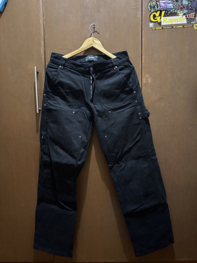 Represent Black Carpenter Pants (Category: Jeans) located in Bacoor. Submitted by hello.curated (Listing ID 1440606184, Image 1). Description: - Brand: Represent - Color: Black - Style: Cargo Pants - Size: Approx. 30 - Features: Multiple pockets, zip details - Closure: Button and zip fly - Ideal for: Everyday wear, streetwear looks.