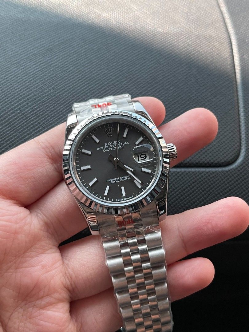 Rx Datejust Fluted Bezel Dark Dial Jubilee Bracelet (Category: Luxury Watches) located in Pasig City. Submitted by gheo0025 (Listing ID 1440721281, Image 2). Description: - Rx Datejust watch - Dark dial with date window - Fluted bezel - Jubilee bracelet - Protective plastic still on - Sharp appearance - Excellent timepiece with Orig box manual card paper bag.