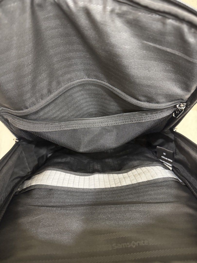 Samsonite Black Backpack with Multiple Compartments (Category: Backpacks) located in Singapore. Submitted by kiatz9 (Listing ID 1440715029, Image 3). Description: - Black Samsonite backpack - Ample storage with built-in organizers - Main compartment features zippered mesh and slip pockets - Front compartment with additional pockets for pens and small items - Padded back and shoulder straps for enhanced comfort - Perfect for work, school, or trave
