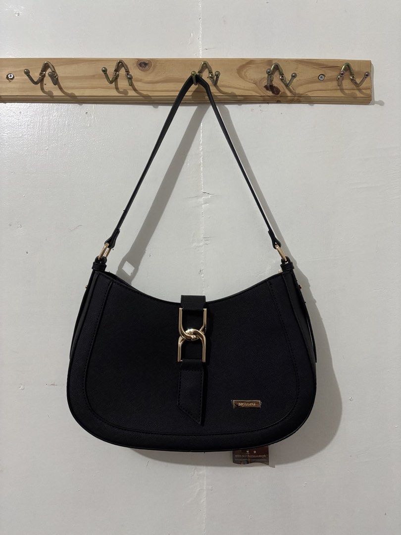 SEACOSANA Anya Plain Shoulder Bag (Category: Shoulder Bags) located in San Fernando, Camarines Sur. Submitted by faye.pltn (Listing ID 1440645874, Image 1). Description: - Secosana black shoulder bag - Gold buckle closure at the front - Zippered pocket on the back - Multiple interior compartments - Adjustable strap - Ideal for everyday use.