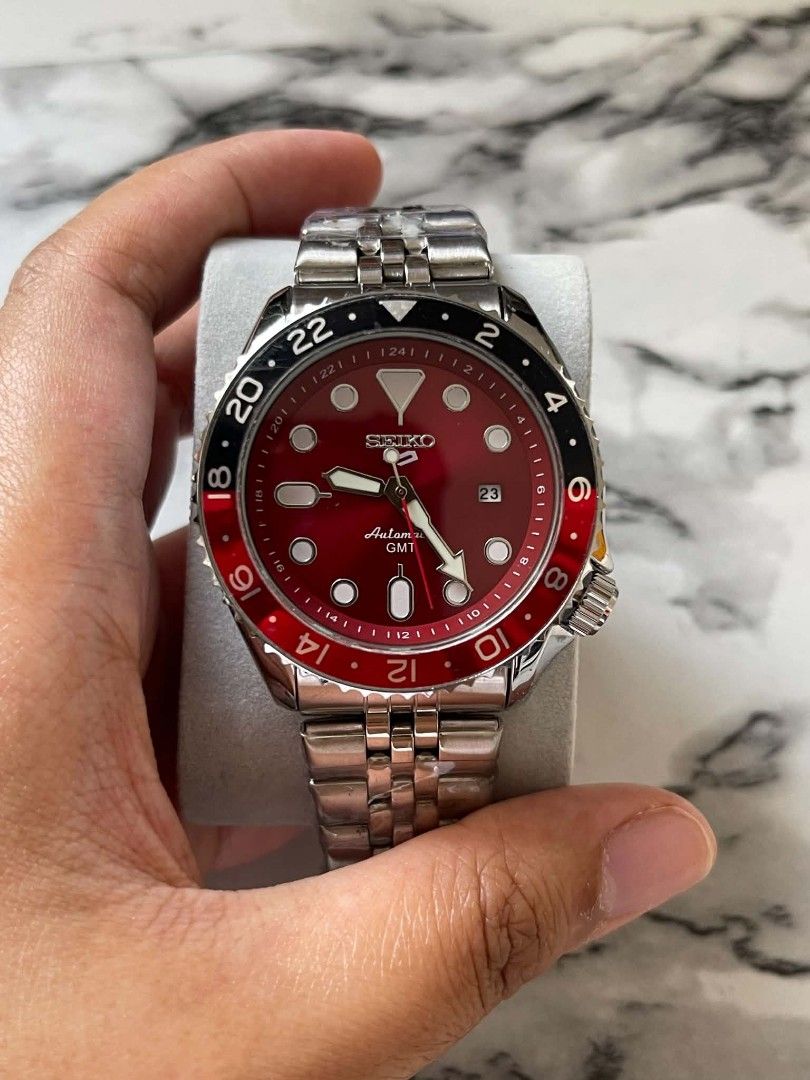 Seiko 5 GMT Coke Automatic Red Dial Watch (Category: Men's Watches) located in Pasig City. Submitted by gheo0025 (Listing ID 1440723997, Image 2). Description: - Striking Red Dial Seiko 5 GMT Watch - Features a Rotating Bezel for easy time zone tracking - Reliable Automatic Movement - Durable Stainless Steel Bracelet - Ideal for Travelers and Everyday Wear - Feel free to ask any questions! with box and paper bag.