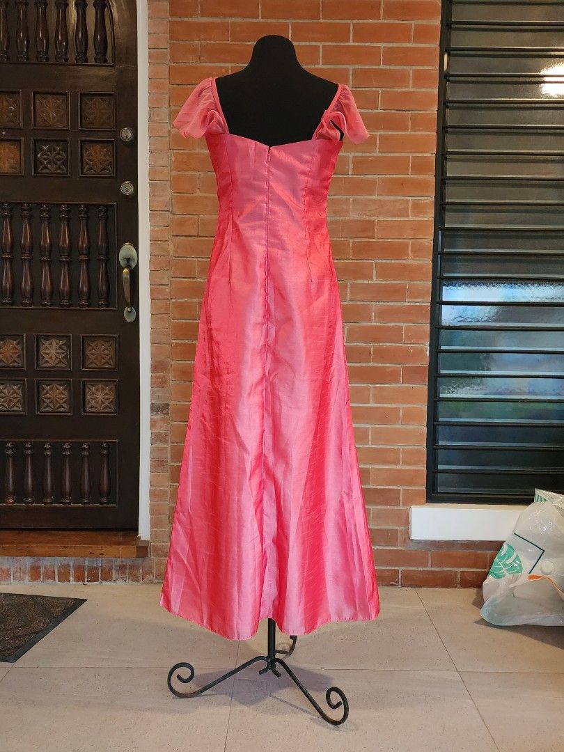 Shimmering Pink Formal Gown with Flutter Sleeves (Category: Evening dresses & gowns) located in Paranaque City. Submitted by nicnavarro (Listing ID 1440702403, Image 2). Description: Elegant floor-length pink formal dress crafted from a fabric with a beautiful, dressy sheen (similar to taffeta or faux silk). The bodice features a square neckline accented by a delicate, sheer draped overlay across the bust, with subtle beading and sequin details j