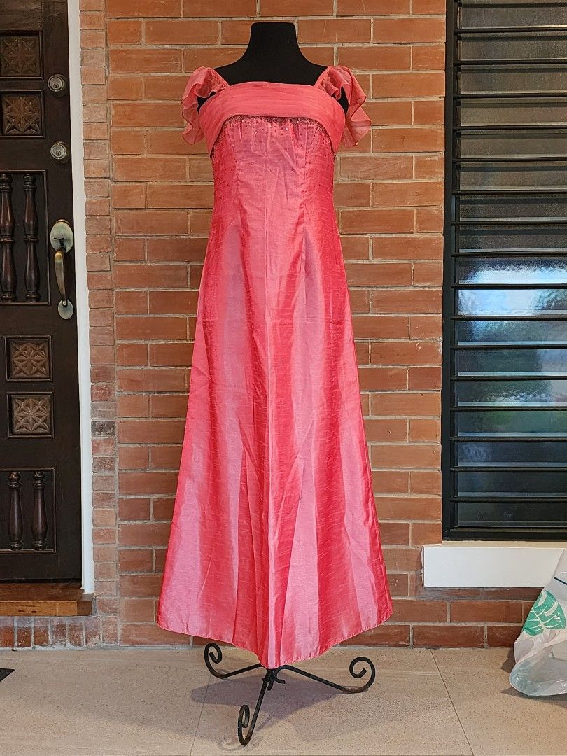 Shimmering Pink Formal Gown with Flutter Sleeves (Category: Evening dresses & gowns) located in Paranaque City. Submitted by nicnavarro (Listing ID 1440702403, Image 1). Description: Elegant floor-length pink formal dress crafted from a fabric with a beautiful, dressy sheen (similar to taffeta or faux silk). The bodice features a square neckline accented by a delicate, sheer draped overlay across the bust, with subtle beading and sequin details j