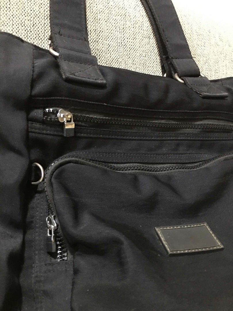SM Grab Black Nylon Tote Bag (Category: Tote Bags) located in Cabuyao City. Submitted by 4everblooms (Listing ID 1440620501, Image 2). Description: ♡ Multiple zippered compartments (front, sides, main) ♡ Interior pockets for organization ♡ Sturdy and reliable handles issues ❗️ Has ink stain inside the middle compartment, the plastic layer of some of the zipper is detaching, and the metal buckle(?) on the handle is a bit rusty mop: gcash only mod: