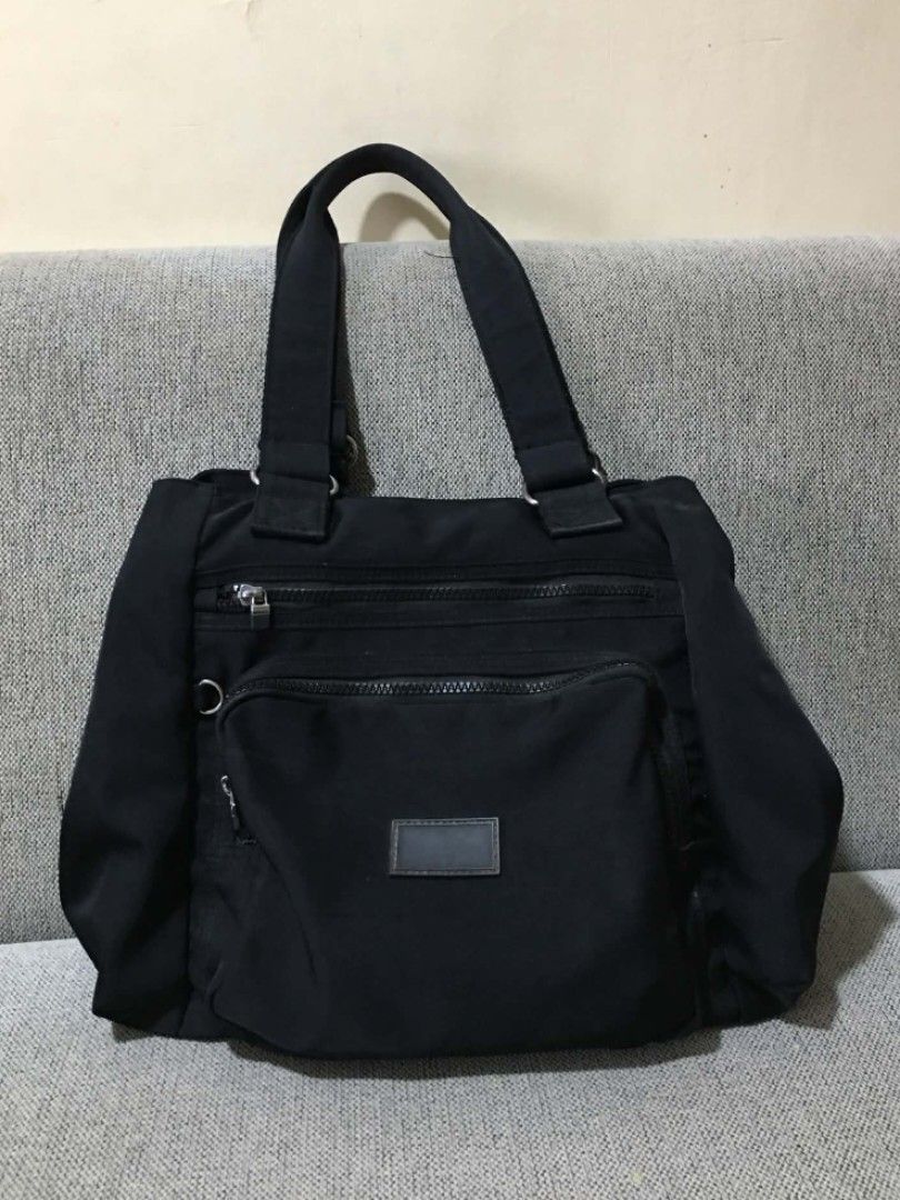 SM Grab Black Nylon Tote Bag (Category: Tote Bags) located in Cabuyao City. Submitted by 4everblooms (Listing ID 1440620501, Image 1). Description: ♡ Multiple zippered compartments (front, sides, main) ♡ Interior pockets for organization ♡ Sturdy and reliable handles issues ❗️ Has ink stain inside the middle compartment, the plastic layer of some of the zipper is detaching, and the metal buckle(?) on the handle is a bit rusty mop: gcash only mod: