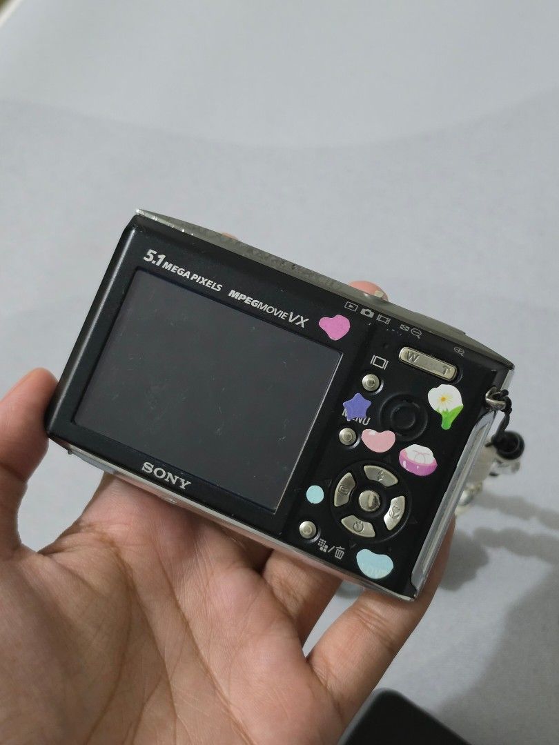 Sony Cyber-shot Digital Camera with Strap and Charger (Category: Cameras) located in Manila. Submitted by mgrbayaborda (Listing ID 1440703582, Image 3). Description: - Cute Sony digital camera - 5.1 Megapixel resolution - Includes fun beaded strap - Comes with Sony charger - Decorated with star and bow stickers - Ideal for taking quick, casual photos - Fully functional and works well.