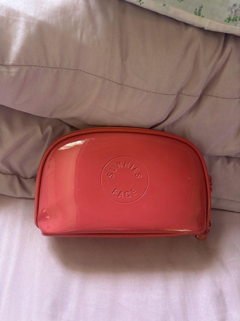 Sunnies Face Makeup Bag Coral Pink (Category: Makeup) located in Binan City. Submitted by kpreloved___ (Listing ID 1440603572, Image 1). Description: - Coral pink makeup bag from Sunnies Face - Patent finish - Zipper closure - Ideal for organizing makeup essentials.