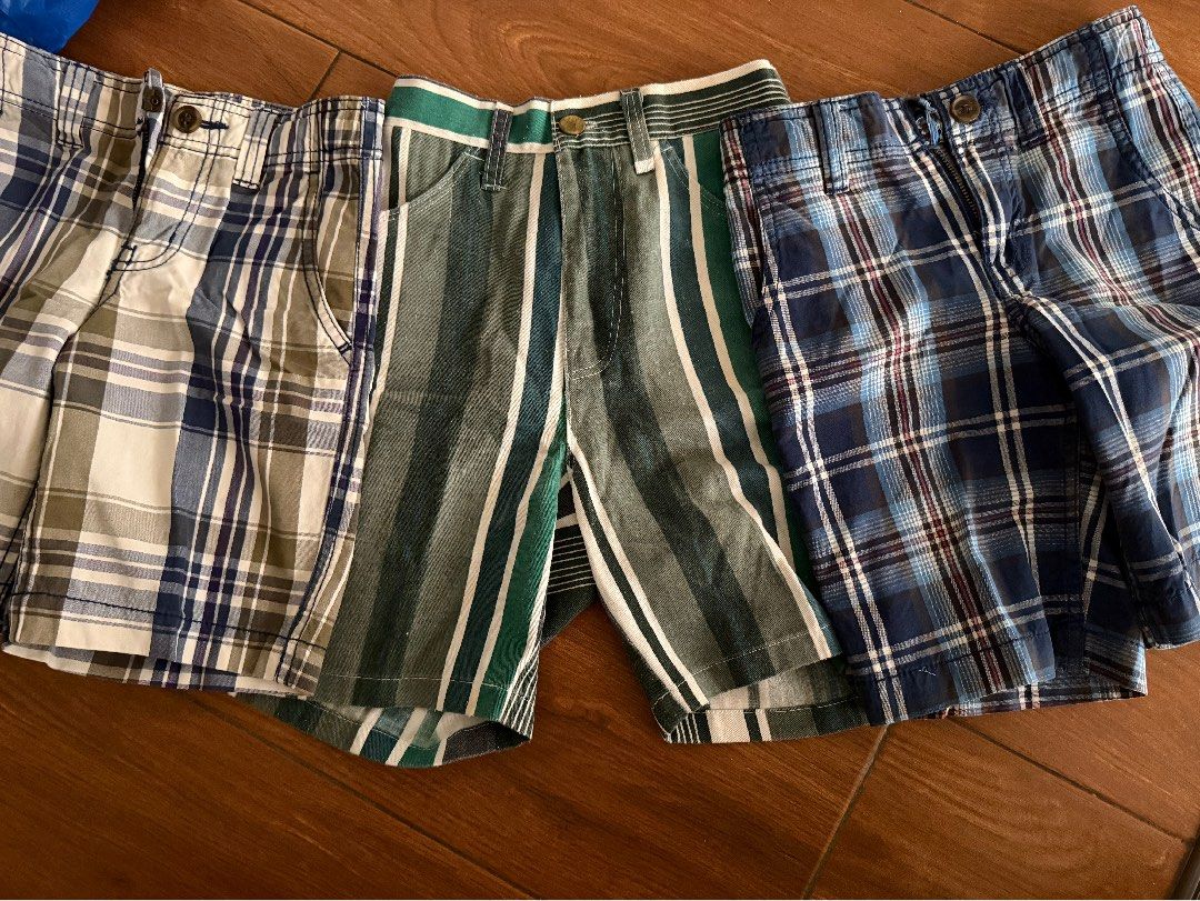 Take all Boys' Plaid and Striped Shorts Bundle (Category: Babies & Kids Fashion) located in Bulacan. Submitted by emjay_17 (Listing ID 1440680270, Image 1). Description: - Bundle of 4 boys' shorts - Includes 2 plaid shorts (blue, beige/green) - Includes 2 striped shorts (green/white, blue/white) - All shorts feature button and zip closure - Ideal for summer wear - Versatile for creating multiple outfits.