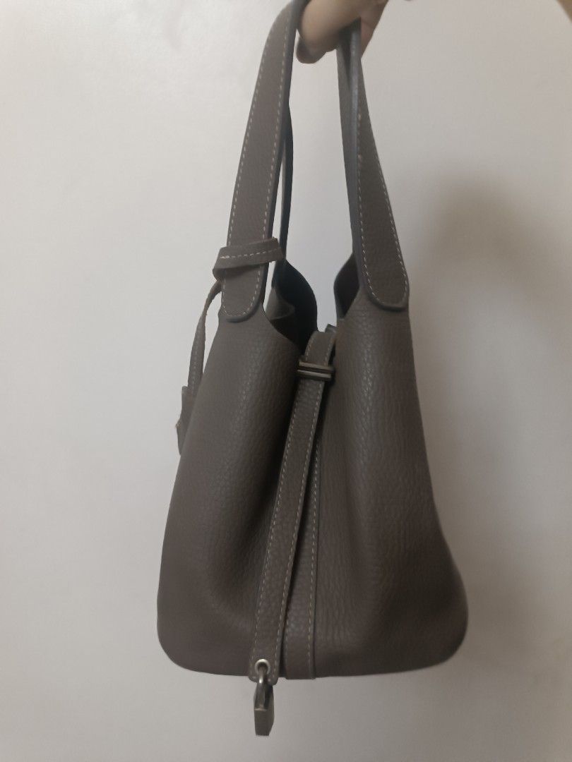 Taupe Leather Bucket Bag with Shoulder Strap (Category: Shoulder Bags) located in Quezon City. Submitted by convert2cash (Listing ID 1440598508, Image 2). Description: - Taupe textured leather bucket bag - Secure drawstring closure - Comfortable shoulder strap - Chic padlock detail - Ideal for daily use.