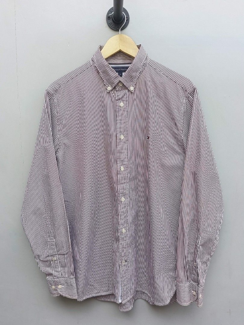 Tommy Hilfiger Men's Striped Button-Down Shirt - Size M (Category: Tshirts & Polo Shirts ) located in Taguig. Submitted by _theroom.ph (Listing ID 1440639996, Image 1). Description: - Brand: Tommy Hilfiger - Color: Burgundy and White Pinstripe - Style: Long-sleeved shirt - Material: 100% Cotton - Fit: Regular Fit - Features: Button-down collar, small embroidered logo on chest - Occasion: Casual or smart-casual wear.
