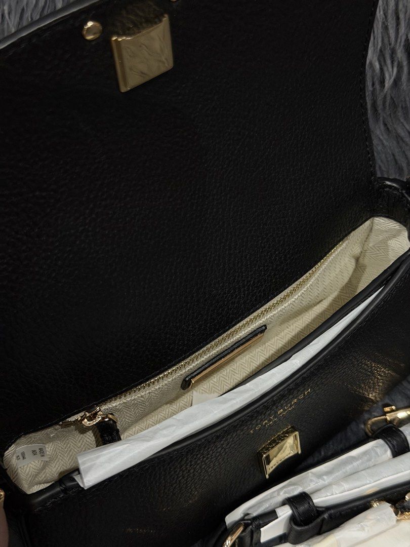 Tory Burch Britten Convertible Shoulder Bag (Category: Cross-body Bags) located in Las Pinas. Submitted by abby022 (Listing ID 1440746502, Image 3). Description: - Authentic Tory Burch shoulder bag in classic black leather. - Elegant gold chain strap with comfortable leather detailing. - Signature Tory Burch logo prominently displayed on the front flap. - Compact and stylish, ideal for both evening events and everyday use..