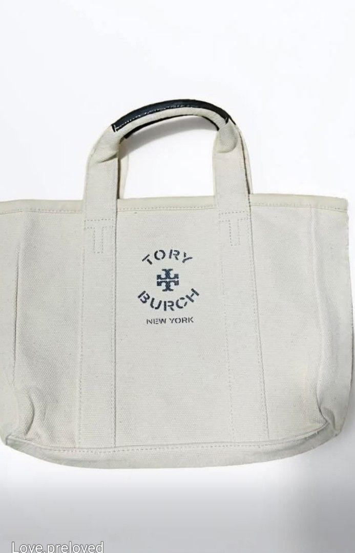 Tory Burch Canvas Tote Bag (Category: Luxury Bags & Wallets) located in Rizal. Submitted by raishin_listings (Listing ID 1439759444, Image 1). Description: - Authentic Tory Burch tote bag - Canvas exterior - Leather handles - Tory Burch logo on front - Minor yellowish stain inside - Black leather handles with white stitching - Perfect for everyday use.