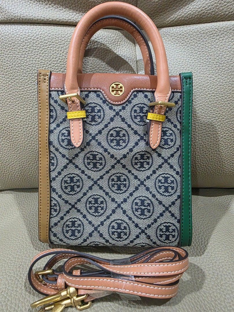 Tory Burch Monogram Mini Tote Bag (Category: Luxury Bags & Wallets) located in Quezon City. Submitted by amcreationz.store (Listing ID 1440665231, Image 2). Description: - Cute Tory Burch mini tote - Classic monogram pattern - Detachable crossbody strap included - Leather handles and trim - Green accent at the top - Ideal for everyday use or a night out.