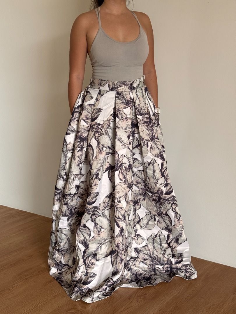 Tropical Leaf Satin Maxi Skirt (Category: Skirts) located in Botolan. Submitted by kstyled (Listing ID 1432859759, Image 1). Description: Elegant Tropical Leaf Satin Maxi Skirt Origin: Boutique find from Thailand Style: High-waisted A-line maxi skirt with a dramatic, voluminous silhouette. Garterized back for a comfier fit. Pattern: Neutral tropical leaf print in shades of mocha, charcoal, pale sage, and cream. Fabric: Premium satin-finish materi