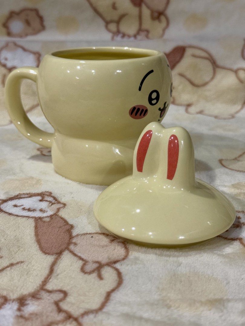 Usagi Ceramic Mug with Lid and Spoon (Category: Coffee & Tea Tableware) located in Taguig. Submitted by karabelle19923 (Listing ID 1440731972, Image 2). Description: - Adorable yellow bunny mug - Comes with a matching lid featuring cute bunny ears - Includes a coordinating spoon - Perfect for coffee, tea, or desk organization - Original box included - Makes a wonderful gift or a treat for yourself!.