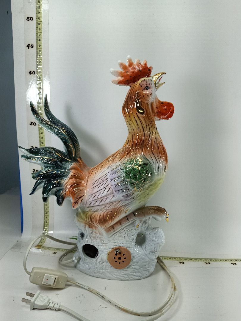 Vintage Ceramic Rooster Figurine Lamp with Light (Category: Other Home Decor) located in Manila. Submitted by oddtiger.5b3e18 (Listing ID 1440591423, Image 2). Description: - Vibrant, multi-colored ceramic rooster figurine - Accented with gold details - Perched on a rock base with greenery - Bright red comb and wattle - Deep blue-green tail feathers - Includes a light cord - Unique decorative item - 42cm height.