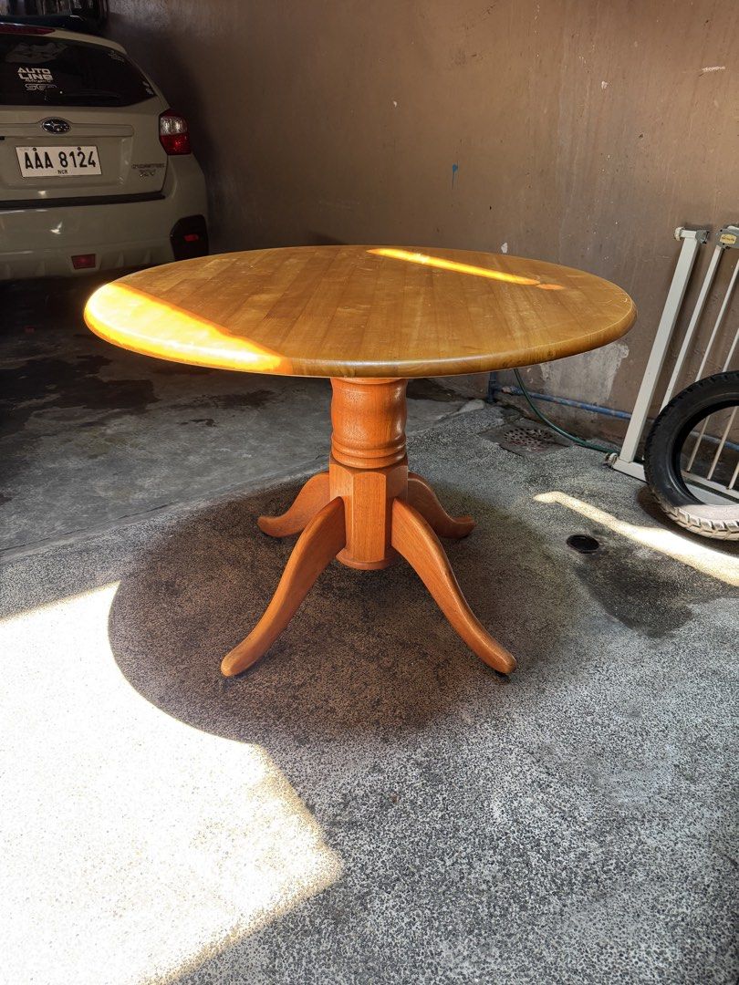 Vintage Round Dining Table (Category: Tables & Sets) located in Manila. Submitted by prpalma (Listing ID 1440605844, Image 1). Description: - Diameter: 107cm; Height: 77cm - Round wooden dining table. - Sturdy pedestal base with four legs. - Warm, natural wood finish. - Made in Malaysia. - Ideal for small dining areas or breakfast nooks..