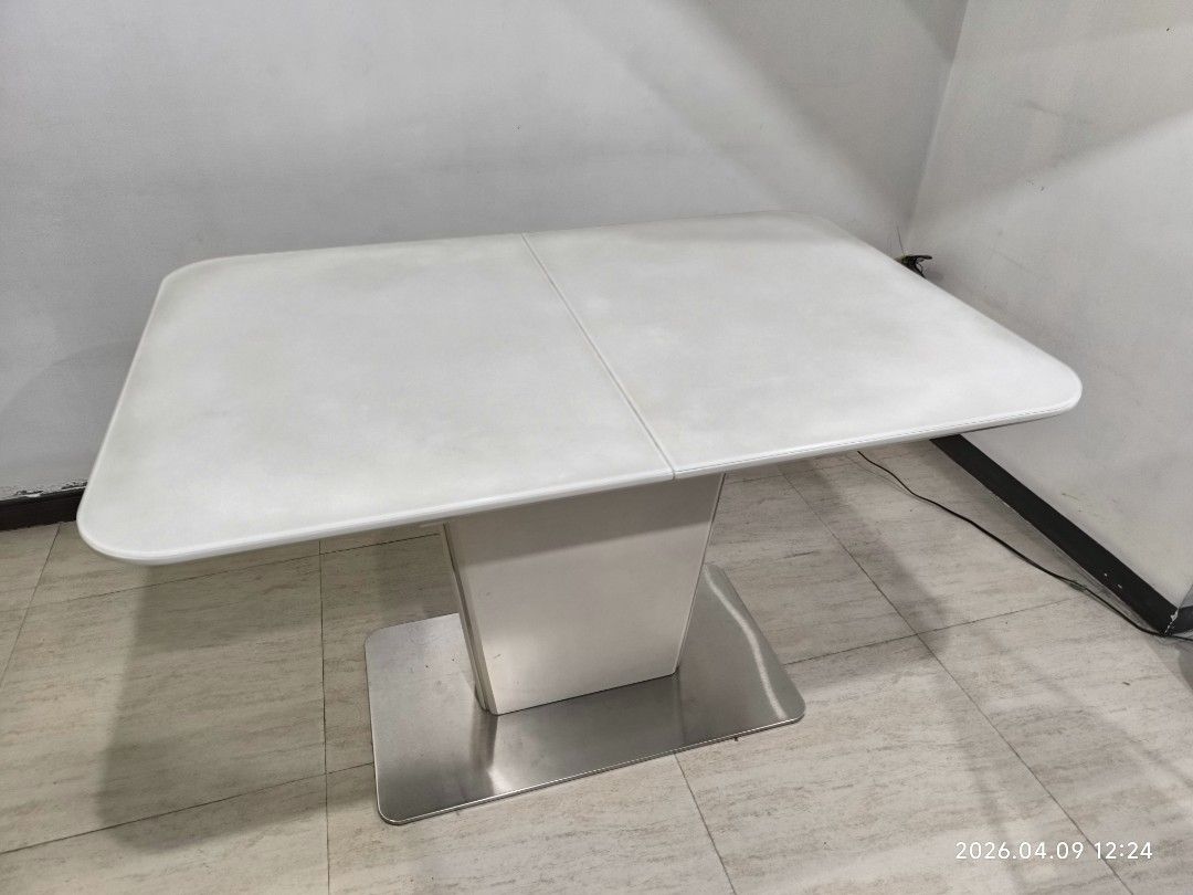 White Extendable Dining Table with Pedestal Base (Category: Tables & Sets) located in Marikina City. Submitted by ronald.santos1 (Listing ID 1440612571, Image 2). Description: - Modern white dining table - Extends to accommodate more guests - Sleek pedestal base with metal stand - Ideal for small or large gatherings - Easy-to-clean surface - Perfect for your dining room.
