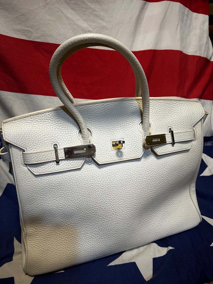 White Leather Handbag (Category: Luxury Bags & Wallets) located in Quezon City. Submitted by ozzy04 (Listing ID 1440688439, Image 1). Description: - Classic white leather handbag - Silver hardware - Top handles - Structured shape - Interior zippered pocket.