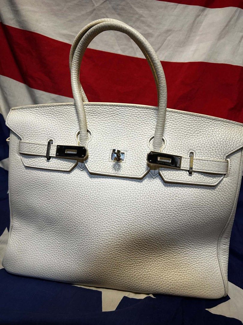White Leather Handbag (Category: Luxury Bags & Wallets) located in Quezon City. Submitted by ozzy04 (Listing ID 1440688439, Image 2). Description: - Classic white leather handbag - Silver hardware - Top handles - Structured shape - Interior zippered pocket.