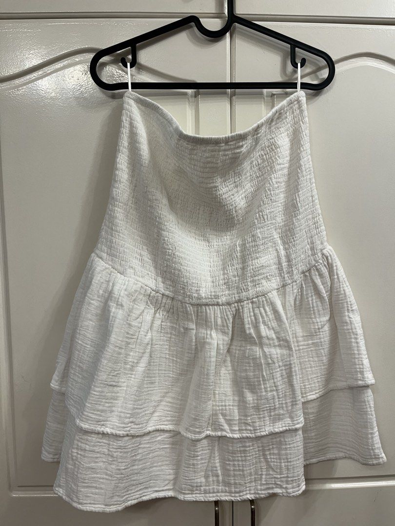 White Smocked Tiered Mini Skirt (Category: Skirts) located in Manila. Submitted by pat.98 (Listing ID 1440618296, Image 1). Description: - Cute white mini skirt - Smocked top part for a comfy fit - Tiered ruffled design for a playful look - Made from lightweight fabric, ideal for summer - Versatile and easy to pair with any top.