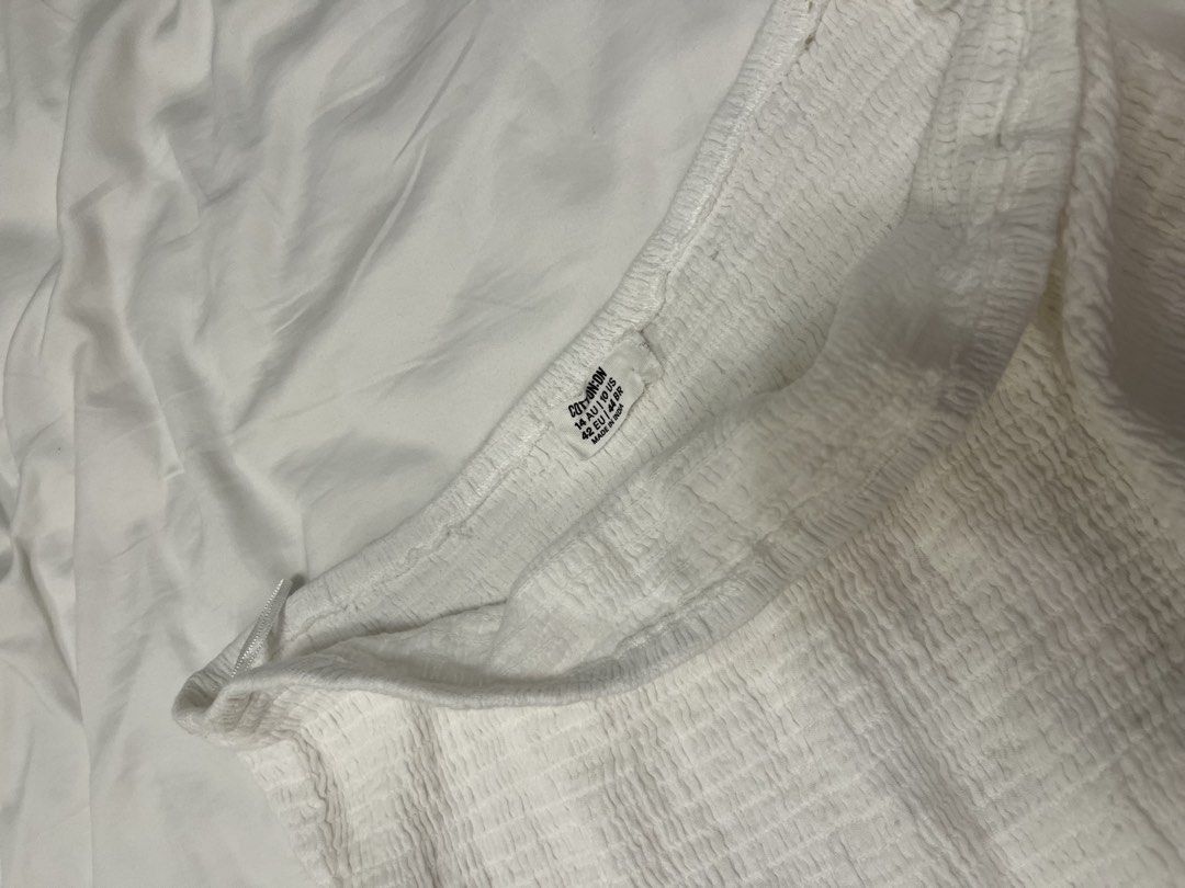 White Smocked Tiered Mini Skirt (Category: Skirts) located in Manila. Submitted by pat.98 (Listing ID 1440618296, Image 3). Description: - Cute white mini skirt - Smocked top part for a comfy fit - Tiered ruffled design for a playful look - Made from lightweight fabric, ideal for summer - Versatile and easy to pair with any top.