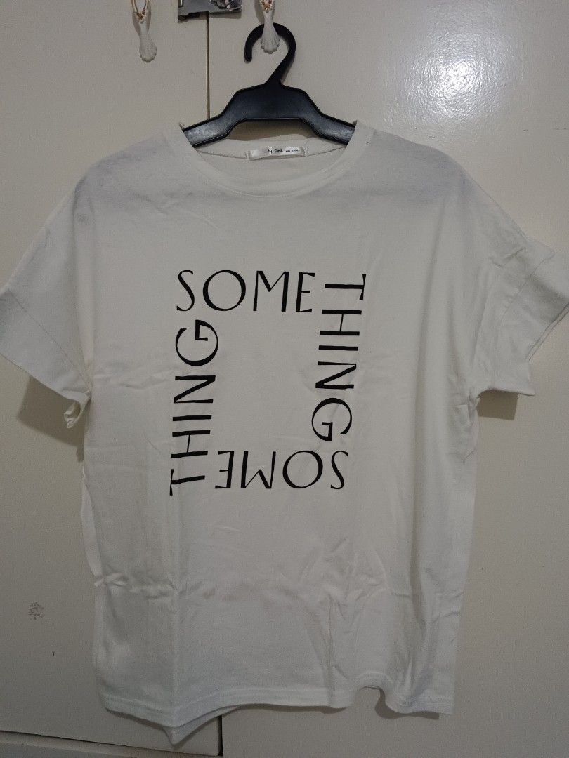White T-shirt with "SOME THING" graphic print (Category: Shirts) located in Rizal. Submitted by mommathings (Listing ID 1440622413, Image 1). Description: - White t-shirt with unique 'SOME THING' square graphic print. - Short sleeves for a classic look. - Relaxed fit for ultimate comfort. - Effortlessly pairs with jeans or shorts. - Ideal for your daily casual outfits..