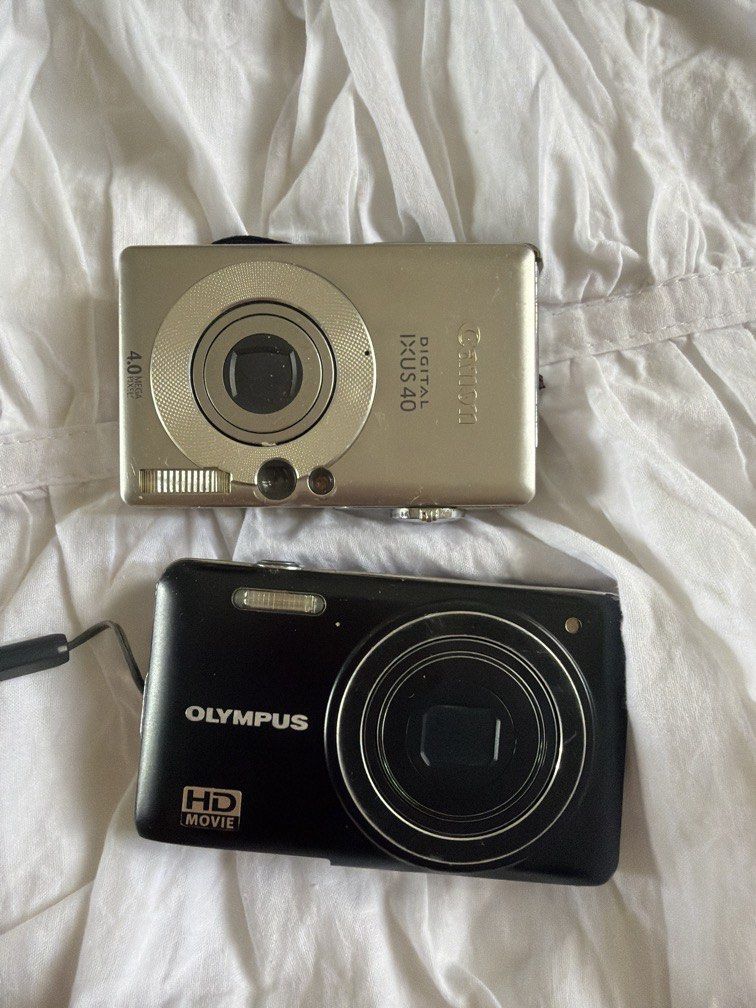 Working digi cam bundle (Category: Cameras) located in San Pedro. Submitted by spreloved1 (Listing ID 1440613473, Image 1). Description: Steal!!! BOTH WORKING but with issues Canon ixus 40 issue - lcd burn + problem with buttons (switching video and photo just have to press really hard for switch) (change batt) - ixus photos are generally nice !!! 🤎🤎🤎 Olympus vg 160 - just change battery + no battery door -- this has really nice film like phot