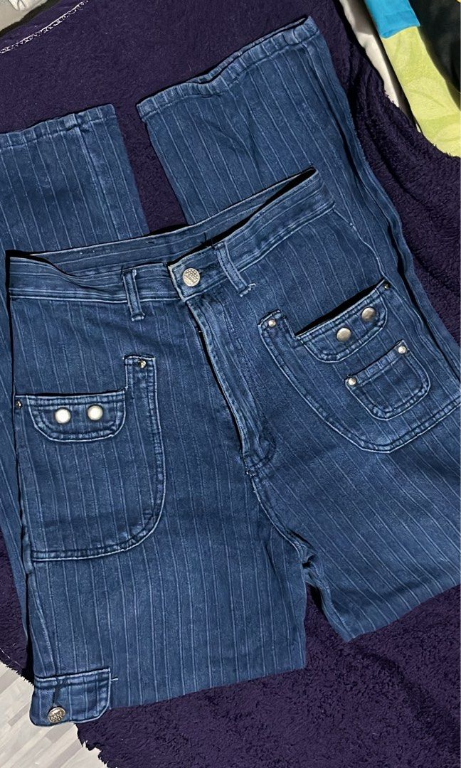 YONGAN Pinstripe Denim Jeans (Category: Jeans) located in Manila. Submitted by grsy.4 (Listing ID 1440663701, Image 1). Description: - Dark wash denim jeans - Subtle pinstripe pattern - High-waisted fit - Wide leg silhouette - Unique pocket details with button closures - Classic five-pocket styling - Perfect for a retro aesthetic - Waistline: 28inches.