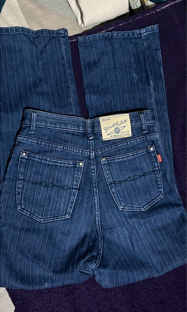 YONGAN Pinstripe Denim Jeans (Category: Jeans) located in Manila. Submitted by grsy.4 (Listing ID 1440663701, Image 2). Description: - Dark wash denim jeans - Subtle pinstripe pattern - High-waisted fit - Wide leg silhouette - Unique pocket details with button closures - Classic five-pocket styling - Perfect for a retro aesthetic - Waistline: 28inches.