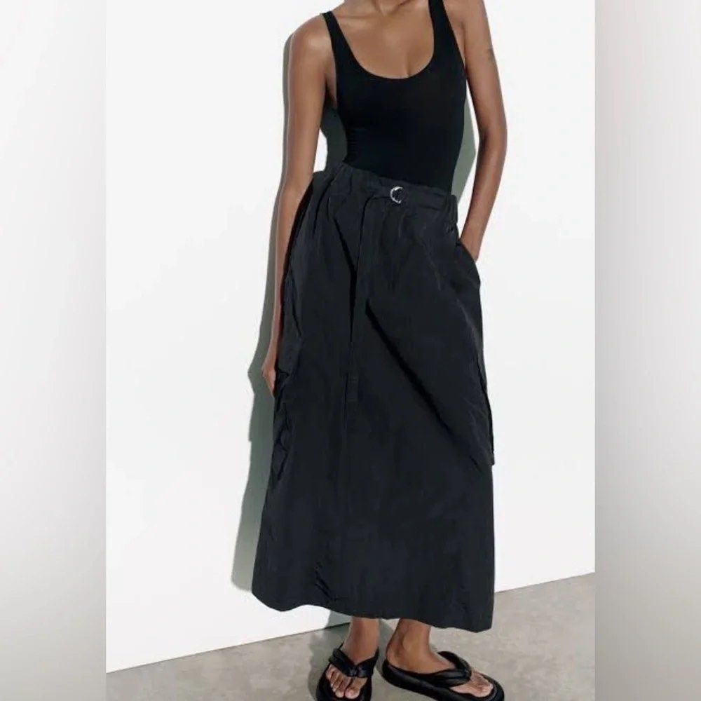 Zara Black Nylon Cargo Maxi Skirt (Category: Skirts) located in Cainta. Submitted by chaspreloved (Listing ID 1440659414, Image 1). Description: Brand new with tags, never worn Features: Elasticated waistband with drawstring and silver ring, side pockets, cargo pockets RFS: too long on me.