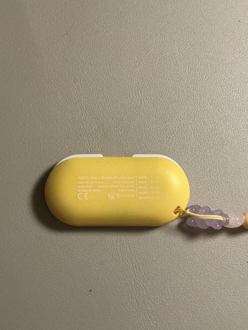 8Bitdo Zero 2 Mini Bluetooth Gamepadyellow (Category: Controllers) located in San Fernando. Submitted by beashopacc (Listing ID 1435785492, Image 2). Description: - 8BitDo Zero 2 Bluetooth gamepad (Yellow) - Compact and portable - Features a D-pad and face buttons - Includes a wrist strap with decorative beads - Used about 5 times only for studying.