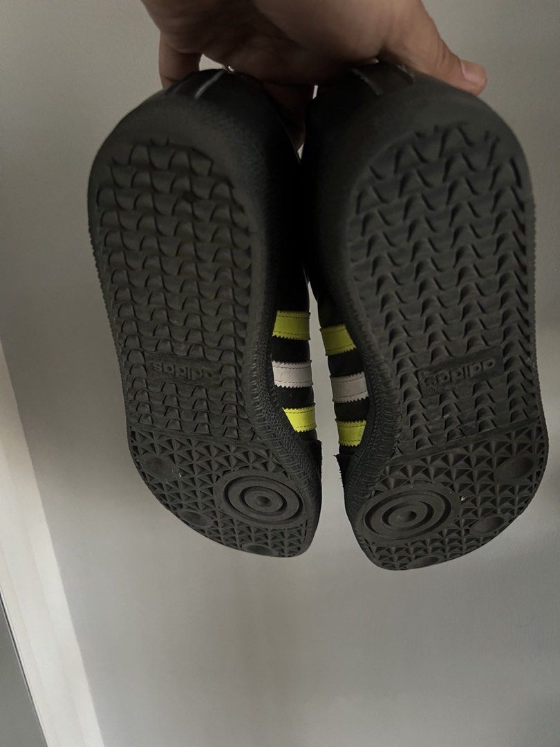 Adidas Samba Black Yellow Sneakers (Category: Sneakers) located in Quezon City. Submitted by Maria.Sierra (Listing ID 1435809586, Image 2). Description: - Adidas Samba sneakers - Black colorway with yellow and white stripes - Features black sole and laces - "SAMBA" text visible on the side - Adidas logo on the tongue - Minimal wear on soles.