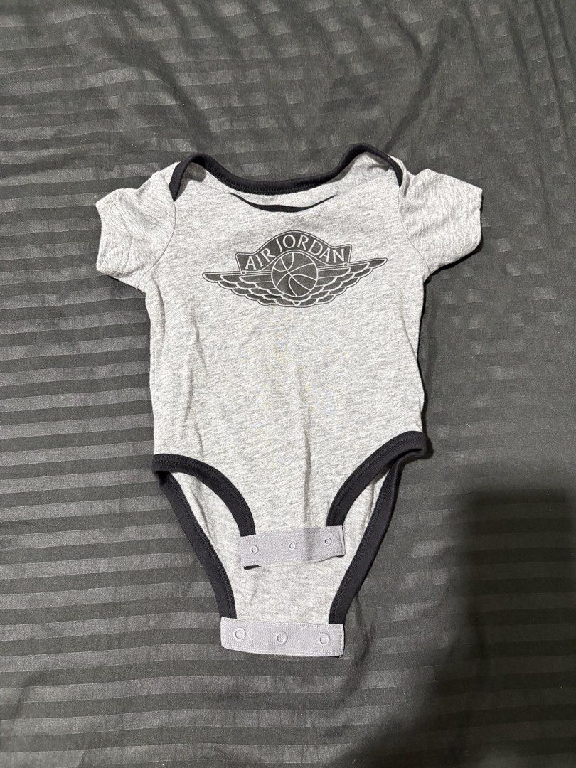 Air Jordan Baby Onesie AUTHENTIC (Category: Babies & Kids Fashion) located in Malabon City. Submitted by chnasntos (Listing ID 1435761031, Image 1). Description: - Air Jordan baby onesie - Gray with black trim - Features the iconic Air Jordan logo - Snap closures at the bottom for easy changes - Comfortable and stylish for your little one ONLY USED TWICE MONEY BACK IF PROVEN FAKE.