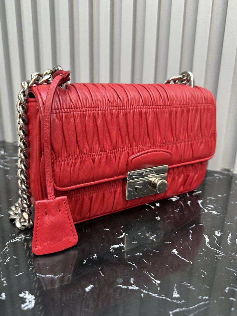 💯AUTHENTIC PRADA RED GAUFRE BAG (Category: Luxury Bags & Wallets) located in Iligan City. Submitted by monfinds (Listing ID 1435780666, Image 2). Description: Personal preloved Rank AB With entrupy cert, in silver hardware, very slight issue light oxidation sa likod check niyo sa photos di naman halata at visible pero declared ko parin kasi honest ako😊, still rank AB for me no rubs still excellent condition🫶 Rfs preferred bigger bag mommy na k