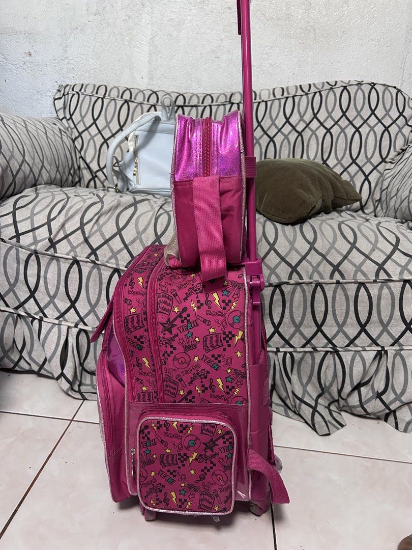 Barbie Rolling Backpack Set ( Trolley school bag) (Category: Babies & Kids Fashion) located in General Trias. Submitted by theosdeclutter (Listing ID 1435732479, Image 2). Description: - Barbie rolling backpack set - Features a vibrant pink design with Barbie graphics - Includes a main rolling backpack, a detachable smaller bag, and a front pocket - Rolling backpack has a retractable handle and wheels - Ideal for school or travel - Offers ample s