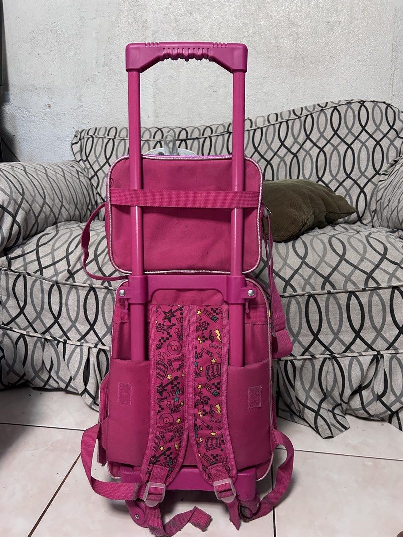 Barbie Rolling Backpack Set ( Trolley school bag) (Category: Babies & Kids Fashion) located in General Trias. Submitted by theosdeclutter (Listing ID 1435732479, Image 3). Description: - Barbie rolling backpack set - Features a vibrant pink design with Barbie graphics - Includes a main rolling backpack, a detachable smaller bag, and a front pocket - Rolling backpack has a retractable handle and wheels - Ideal for school or travel - Offers ample s