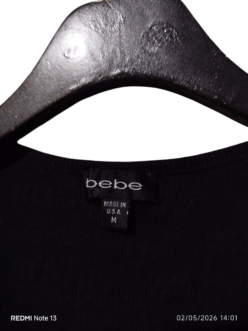Bebe Tank Top All Over Print (Category: Sleeveless) located in San Juan (Cabalian). Submitted by ec8thrift (Listing ID 1435723228, Image 3). Description: - Bebe black tank top - Features scoop neck - 'Sexy glam @ bebe' text - Size M - Ribbed texture - Made in USA - Fabric: 93% cotton, 7% spandex.