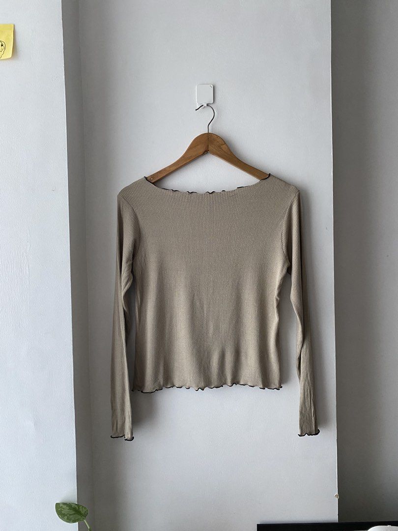 Beige Long Sleeve Top with Black Trim (Category: Longsleeves) located in Makati City. Submitted by kxthr (Listing ID 1435740751, Image 1). Description: - Beige long-sleeved top - Black wavy trim on neckline, hem, and sleeves - Ribbed texture - Decorative black seam down the center - Scoop neckline - Lightweight material - Perfect for layering - Versatile style.