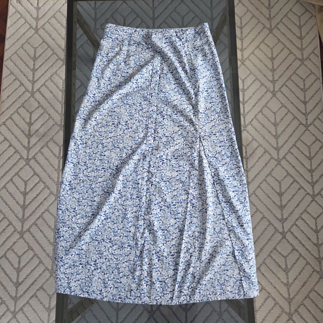 Blue Floral Maxi Skirt (Category: Skirts) located in Cebu City. Submitted by minkbuys (Listing ID 1435821430, Image 1). Description: - Blue and white floral maxi skirt - Features a stylish front slit - Made of lightweight fabric - Comfortable and flowy fit - Ideal for warm weather.