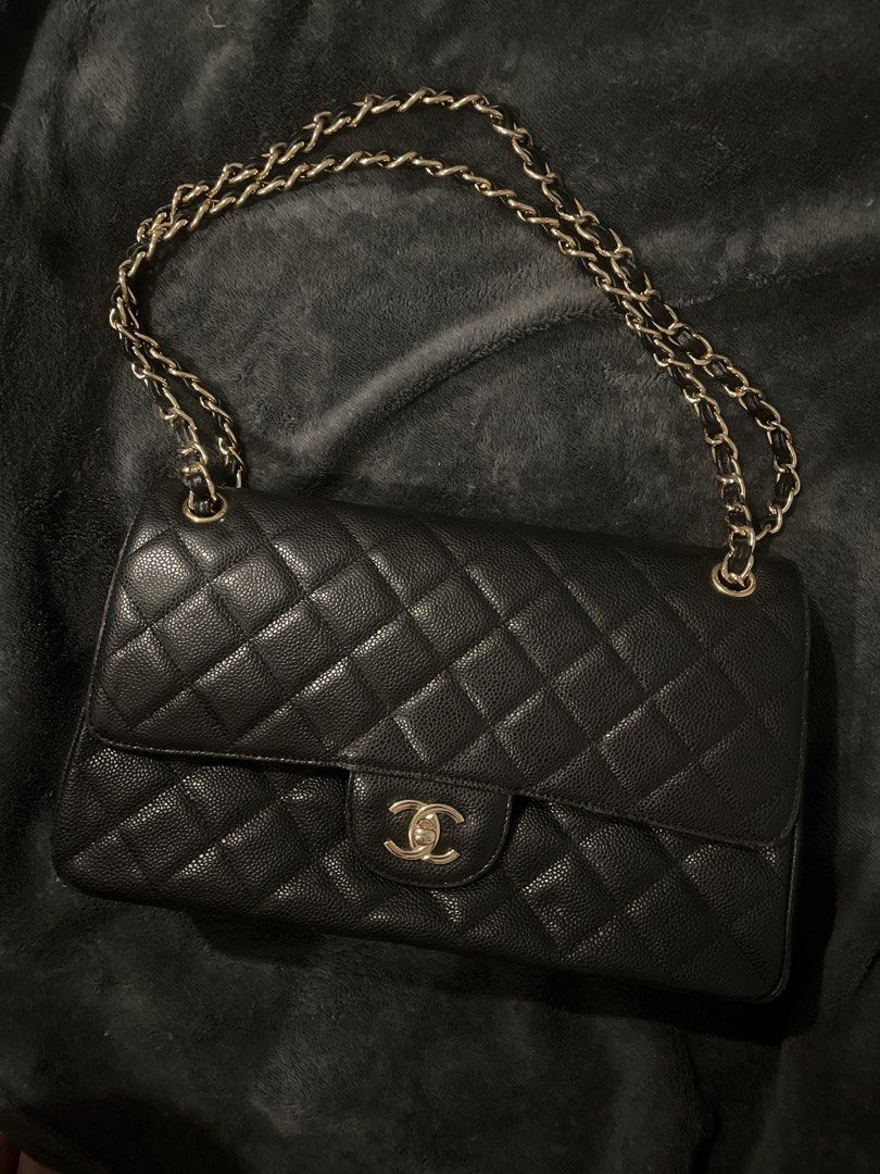 Chanel Classic Flap Bag (Category: Luxury Bags & Wallets) located in Malabon City. Submitted by justprelovedbyazi (Listing ID 1435888789, Image 1). Description: - Chanel Classic Flap bag - Black quilted exterior - Gold-tone hardware - Chain strap - Red interior with zippered pocket - Made in France.