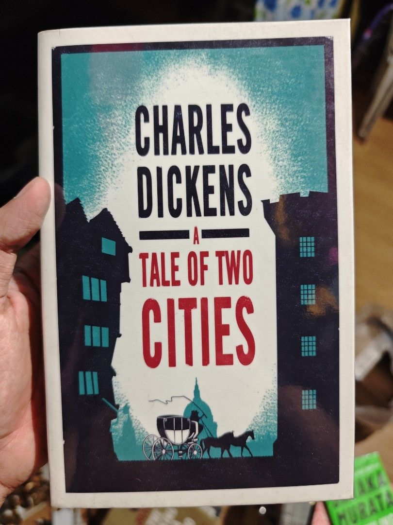Charles Dickens A Tale of Two Cities (Category: Storybooks) located in Bulacan. Submitted by bertiinggg (Listing ID 1435901869, Image 1). Description: Classic novel "A Tale of Two Cities" by Charles Dickens. illustration of a carriage and buildings..