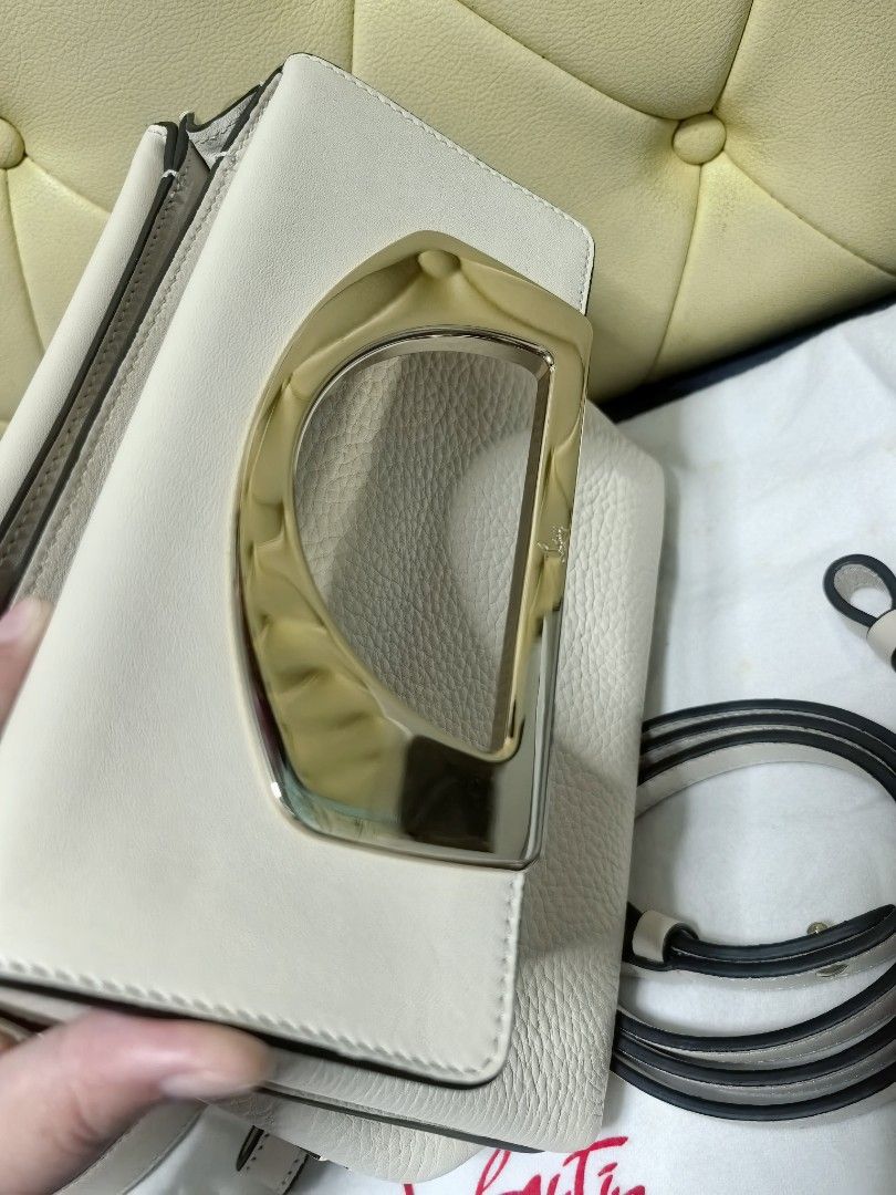 Christian Louboutin Handbag with Shoulder Strap (Category: Luxury Bags & Wallets) located in Makati City. Submitted by reiven2017 (Listing ID 1435893865, Image 3). Description: - Christian Louboutin handbag - Light beige color - Gold-toned handle - Two detachable straps - Red fabric interior - Includes dust bag with logo -almost new -bought abroad.