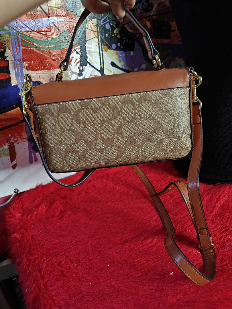 Coach Brown Crossbody Handbag (Category: Luxury Bags & Wallets) located in Las Pinas. Submitted by liezel49 (Listing ID 1435874529, Image 3). Description: - Authentic Coach handbag - Brown leather exterior - Signature Coach pattern on the bottom - Top handle and detachable crossbody strap - Light-colored fabric lining - Interior pocket - Gold-tone hardware - Flap closure.